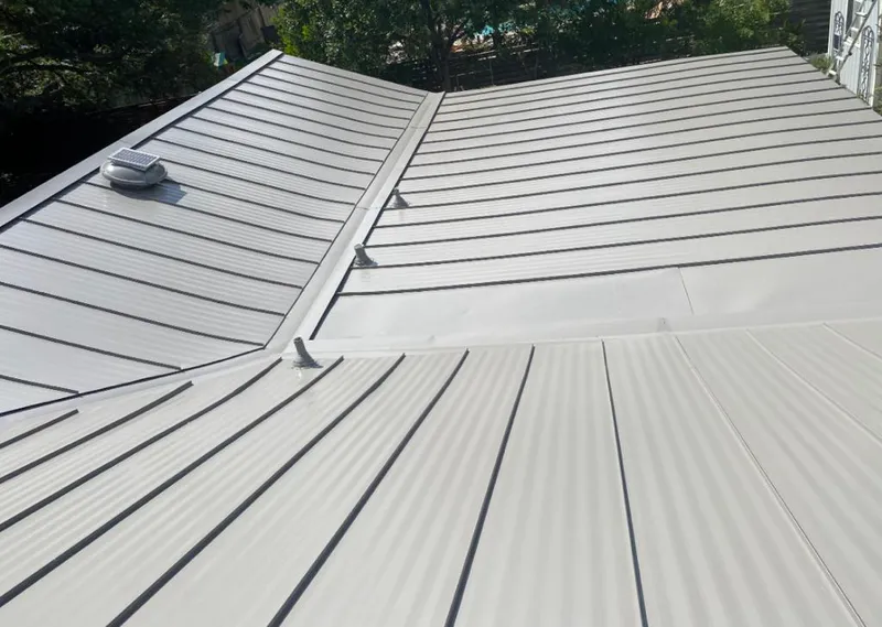 Solar attic fan installed on a metal roof for Roof Ventilation in Nottingham